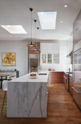 A long counter height island separates guests from kitchen.