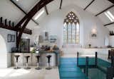 In Kelso, Scotland, a centuries-old stone church was converted into a five-bedroom house—which you can actually rent out—where the upper floor of the church is one large, open space that houses a kitchen, dining area, living room, and game space. The open plan also allows attention to be focused on the pointed arch windows along the front facade.
