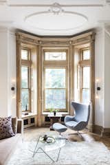 A brownstone in Brooklyn, New York, was renovated by interior designer Kiki Dennis, complete with a full restoration of the wood window framing and decorative moldings. As much of the original fabric was retained as possible.