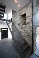 Separating the interior of the home from the exterior courtyard are exposed load-bearing limestone walls.