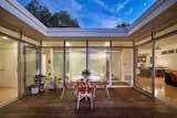 Outdoor and Wood Patio, Porch, Deck The patio is open to the sky above, allowing for light to flood the rooms that surround it.  Photo 5 of 14 in A Midcentury-Modern Home in L.A. Designed by Richard Banta Is For Sale For $899K