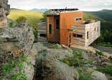 Tomecek Studio’s Container House in Nederland, Colorado, is a 1,500-square-foot residence anchored into a rock outcropping. The dwelling—which comprises two insulated shipping containers clad in fireproof plank siding—is powered by photovoltaic rooftop panels and takes advantage of passive solar strategies to keep energy demands to a minimum.
