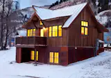 Based in Poncha Springs, Colorado, Great Western Homes designs and builds a range of homes that have a modern, rustic edge. By mixing materials -- wood, weathered steel, and a standing seam metal roof, this residence is a modern take on a classic cabin, with steeply pitched roofs for shedding snow.