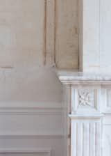 A detail of the historic marble fireplace and original plaster in the more formal rooms that look out onto the street.&nbsp;