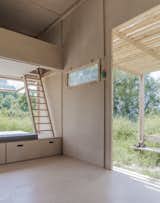 Living Room, Plywood Floor, and Bench Beds are lofted above the kitchenette and large bench, and are accessible by wooden ladders.

  Search “living on water stilted villages” from This Off-Grid Turkish Cabin Features a Nifty Pulley System