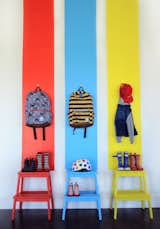 Painted wooden IKEA stools perk up an entire wall.