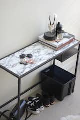 Some black spray paint and marble contact paper easily transform this table.