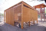 On some sides, the chicken coop features wood siding rather than louvered wood because of the orientation to the sun.