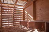 Boxes where the chickens can nest and lay eggs are located on one side of the coop.