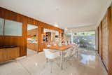 The dining room opens to the kitchen, which features glazing to the yard. The flooring here is the original terrazzo.