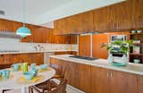 Kitchen, Dishwasher, Wall Oven, Range, Cooktops, Range Hood, Terrazzo Floor, Refrigerator, Pendant Lighting, Microwave, and Wood Cabinet The charming kitchen retains its original walnut cabinets.

  Photos from An Alluring Kazumi Adachi Home Is Listed For $1.79M