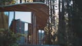 Exterior, Wood, House, Glass, and Curved The wood for the home was harvested and dressed from Bello's property.  Exterior House Glass Curved Photos from The Parabolic Glass House in Northern California Is One Architect’s Utopia in the Redwoods
