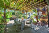 The kitchen opens out onto the back yard, complete with a pergola.  Photo 7 of 13 in A Midcentury Charmer in the Bay Area Is Listed at $749K