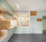 The sleeping area is raised and flush with the height of the countertops, allowing for storage underneath.