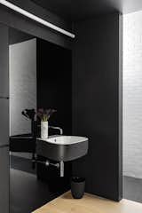 The bathroom is mostly black, allowing selected moments of white to really pop.