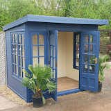 This backyard shed, painted a soulful blue and full of light from windows on three sides, is a great example of a kit she shed. It's the perfect place to escape to for some yoga, art, or reading.