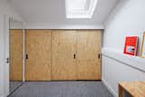 The bedroom closet features sliding oriented strand board doors and black hardware.