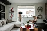 In this apartment, Kesha Franklin of Halden Interiors employs a palette of off-whites paired with a dark floor; moments of red in both the artwork and accent furniture enliven the space.