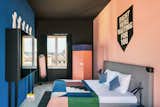 The guest rooms continue the design themes found in the rest of the hotel, with cheeky artwork, bold colors, and geometric textiles.