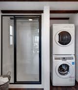 The home is also outfitted with a full bathroom with a composting toilet and a stacked washer-dryer unit.