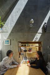 Living Room, Bench, and Wall Lighting The couple made several decisions about the home together, from the appropriate size to the types of spaces they needed.  Photo 7 of 12 in A Concrete Tiny House in Tokyo Opens to the Sky—and the Street