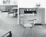 In 1958, the Rosewood Group was renamed Thin Edge not because of its revamped profiles and forms, but because of the expanded range of options and the inclusion of hardwood veneers on the furniture. Pieces like the Pretzel Chair provided an airy, sculptural counterpart to more rigid, regular lines of the group's chests and desks. The Pretzel Chair, made out of laminated and bent plywood and first produced in 1952, was very influential in the development of the more-popular Cherner armchair, also made out of bent laminated plywood. (No. 5733 Thin Edge chest desk with No. 5890 Pretzel chair designed by George Nelson, 1958.)