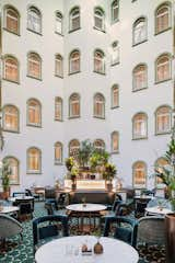 Paris Court is one of the only buildings in Budapest with a courtyard—and this space became an important part of the renovation. The architects enclosed it with a new glazed skylight, allowing it to function as a restaurant for the new hotel.