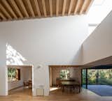 Ceilings are typically composed of simple white plaster or exposed wood beams. The flooring, furniture, and window frames are also wood.