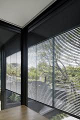 The louvered facade on the north side of the home filters light and provides privacy from the street. Mechanically controlled window shades can be brought down at night for additional privacy and room darkening.