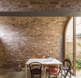 The brick walls of the extension provide a warm, textured interior that requires little more than simple furnishings and light fittings to feel comfortable and lived in.