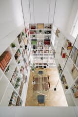 The shelves display the homeowners’ books, records, clothing, and more, bringing personality to the spaces while still creating a regularity with its straight lines and consistent spacing.