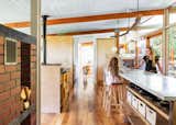 Kasey and Nick chose to keep the long, reclaimed-marble countertop in the kitchen, which had been renovated by the previous owners of the 1954 Wendell Lovett home.