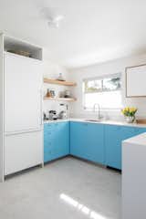 Kitchen, Colorful, White, Refrigerator, Engineered Quartz, and Ceiling "We had all white cabinets in our NY kitchen and wanted to try something different and more colorful here,  Kitchen Engineered Quartz White Refrigerator Photos from Budget Breakdown: An Interior Designer Livens Up Her Dated Kitchen for $57K