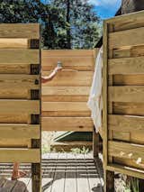 The yard also features a rustic outdoor shower.