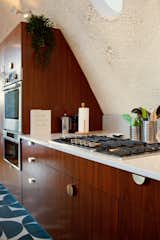 “DAAM's design mirrors Rutkin's concept of wrapping the kitchen around the shell,” notes Agnello. However, it differs in the orientation and location of cooking equipment to allow for more optimal functional spacing.  Photo 8 of 14 in Before & After: A New Kitchen Celebrates the Curves of a Dome-Shaped Home in New York