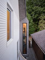 By stepping the facade back for the entry, windows were able to be placed at sides of the home, where it narrows. This brings in natural light into the middle of the home, which would have otherwise been quite dark.