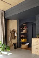 This alcove, which features storage on one side, leads to a powder room that is within close proximity of Wakoko, her team or her children when they are working in the studio.