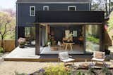 The view from the garden into the studio shows its relationship to the rest of the house. Wakoko also used sustainable materials in the outdoor area and used fast-growing, locally grown robinia wood planks for the terrace.