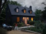 The window shutters were removed, old windows were replaced with new windows without muntins, and new siding with a vertical emphasis was installed.