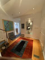 The original entry sequence was convoluted, and the spindles on the banister were painted white. Flooring was typically strip oak with a strong grain.