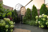 The main point of inspiration for the garden was the feeling of a hidden courtyard. The wood fence, covered in part by taller trees, shields the garden from the street and creates that sense of discovery.