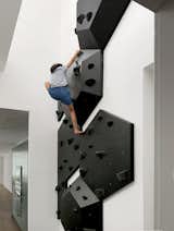 The two-unit home has four bedrooms and six bathrooms across its three stories and 4,200 square feet. The climbing wall is located on the only double-height space in the home, on the third floor near the kitchen.