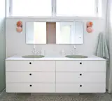 Custom pieces included bathroom vanities in all bathrooms, a custom bookshelf in the girls’ room, a custom standing desk and bookshelves for the home office, the headboard and closet in the parents’ suite, and the headboard and side table in the ADU.