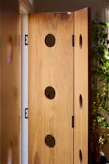 The shutters create the right balance between new and old and daylight and privacy. “Her kitty can still sunbathe with the light that does stream in and the holes create a fun effect that bounces around the space when the shutters are closed,