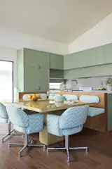 <span style="font-family: Theinhardt, -apple-system, BlinkMacSystemFont, "Segoe UI", Roboto, Oxygen-Sans, Ubuntu, Cantarell, "Helvetica Neue", sans-serif;">The home was designed with one full kitchen and a kitchenette on the second floor, to accommodate the homeowner's extended family. </span>Both the kitchen and the kitchenette, pictured here, use color in playful and eye-catching ways.