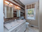 Bath Room The Grantham Lakehouse - bathroom. Wood siding on the interior brings out outdoor elements in.  Photo 5 of 12 in The Grantham Lakehouse by Yankee Barn Homes