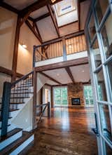 Staircase and Wood Tread The Grantham Lakehouse - post and beam living is a beautiful thing.  Photo 4 of 12 in The Grantham Lakehouse by Yankee Barn Homes