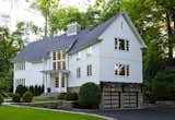 The home's unique blend of modern and barn design is defined by the vertical and horizontal siding patterns that emulate the feel of a classic New England Barn. The locally sourced stone is very natural and harkens to traditional stone foundations of the area.

Modern touches include sleek trim detailing, clean lines in the windows, frosted glass paneled garage doors and dark stained wood awning over the garage.