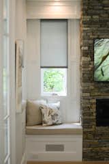 On either side of the fireplace in the family room are cozy nooks that cleverly hide the surround sound system. Automatic shades powered by the Crestron home automation system lend to a long list of lifestyle enhancements this home was built around.