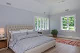 The generously sized master bedroom  is large enough for a king size bed and sitting area. Dual exposure windows let in tons of natural light while the cove ceiling adds height and visual interest to the space.